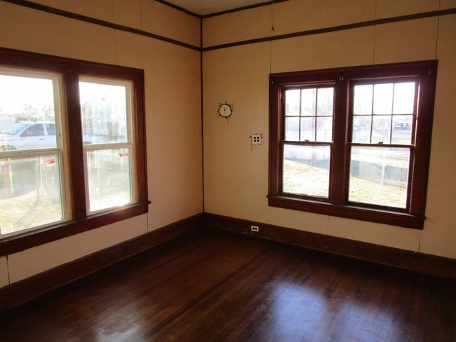 Spare room featuring dark wood-style floors and baseboards | Image 16