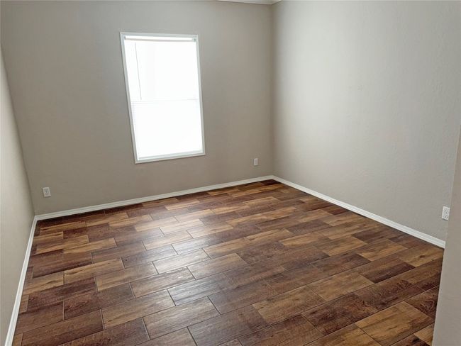 Spare room featuring dark wood-style flooring and baseboards | Image 22