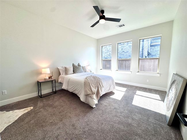Bedroom featuring dark colored carpet and ceiling fan | Image 19