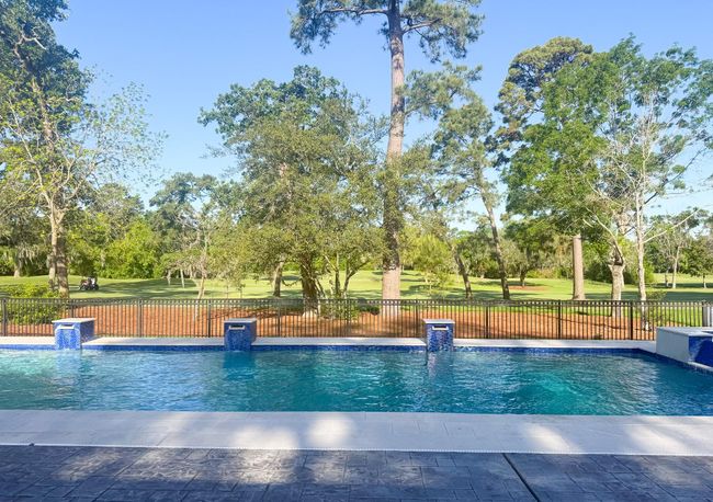The sparkling lap pool overlooks the lush golf course greens, offering a serene and luxurious backdrop for entertaining, relaxing, or enjoying a morning swim. | Image 26