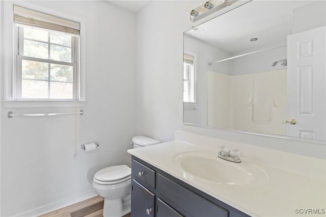 Bathroom with vanity, wood finished floors, and a shower | Image 20