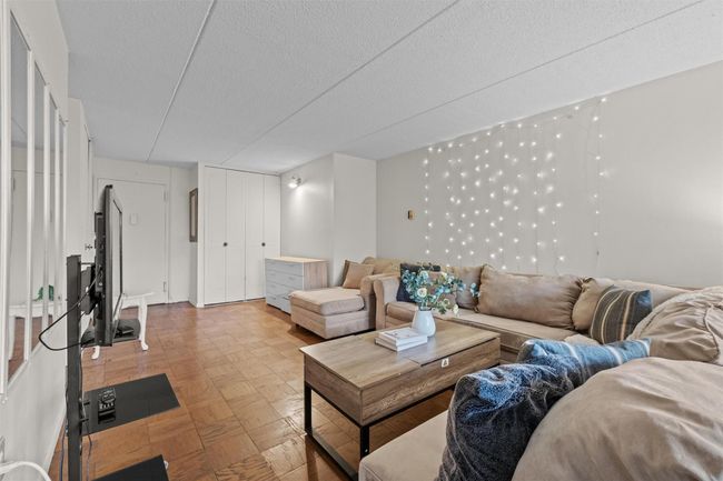 Living room featuring a textured ceiling and light flooring | Image 5