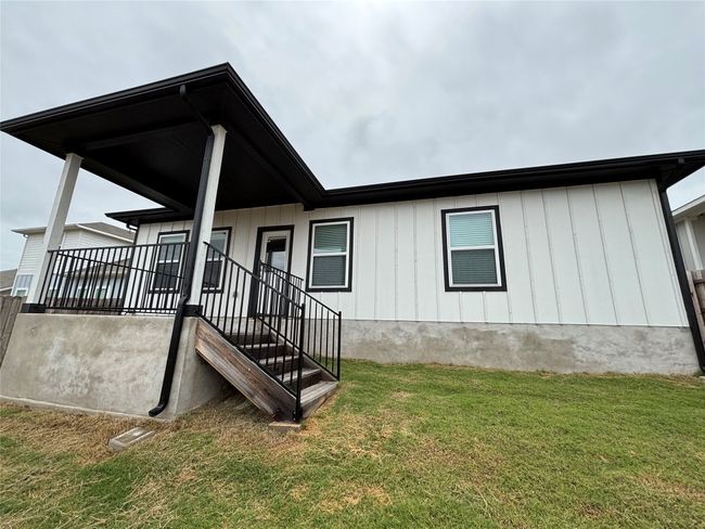 Back of property with a yard and board and batten siding | Image 18