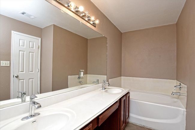 Full bathroom featuring a garden tub, double vanity, and tile patterned floors | Image 17
