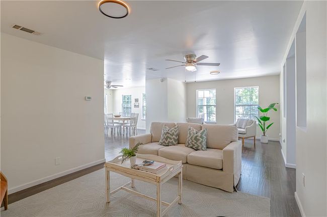 Living room featuring light wood-type flooring and ceiling fan | Image 14