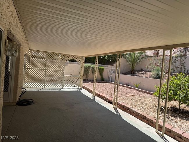 Fenced backyard with a patio area | Image 14