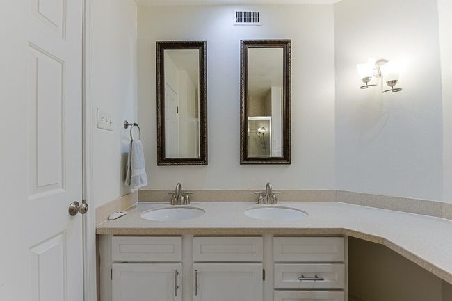 Bathroom with double vanity, visible vents, and a sink | Image 14