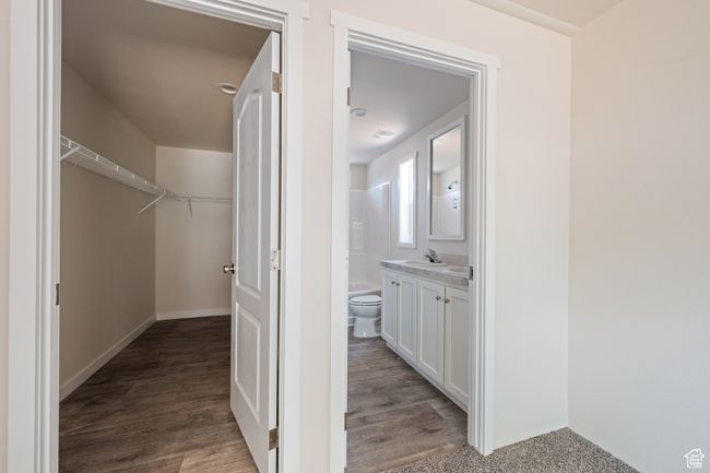 Bathroom with vanity, toilet, wood finished floors, and a spacious closet | Image 12