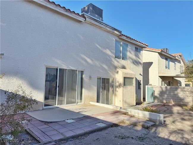 Rear view of house with stucco siding and a tile roof | Image 49