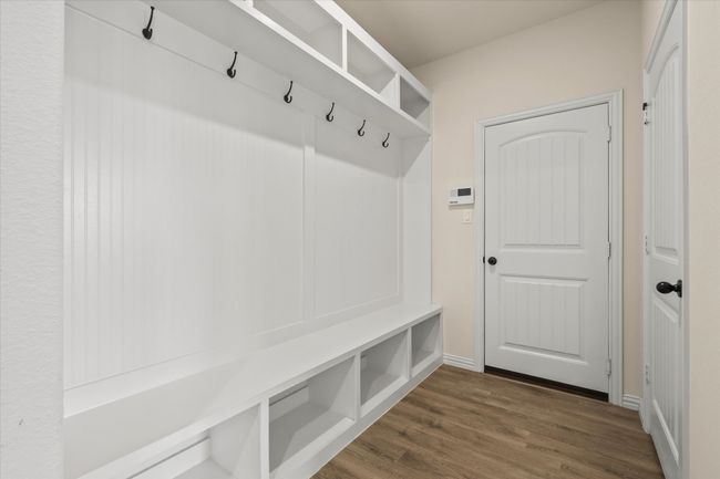 Mudroom featuring dark wood-type flooring and baseboards | Image 9