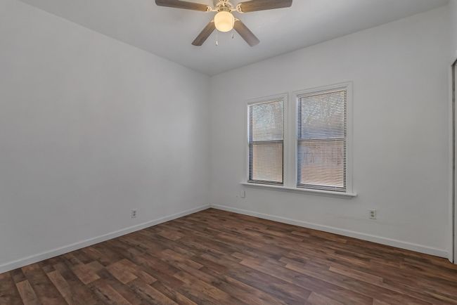 Unfurnished room with dark hardwood / wood-style flooring and ceiling fan | Image 29