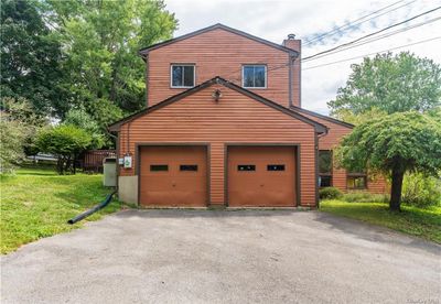 Garage featuring a lawn | Image 3