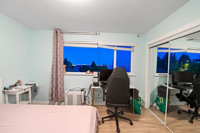 Bedroom with a closet and wood finished floors | Image 21