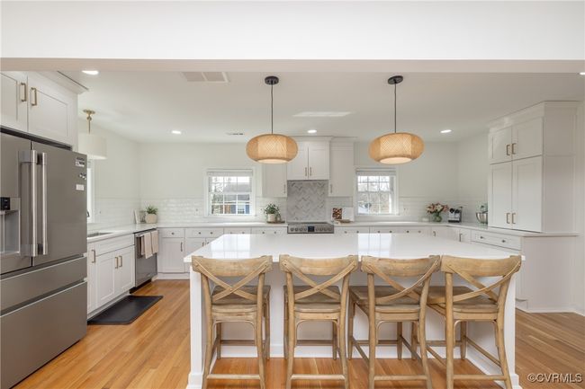 Kitchen with light countertops, visible vents, a center island, and appliances with stainless steel finishes | Image 8
