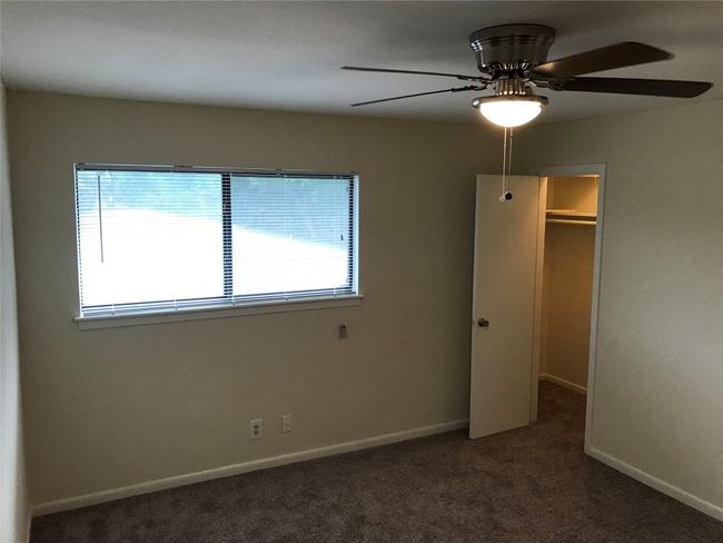 Unfurnished bedroom with multiple windows, a closet, baseboards, and carpet | Image 10