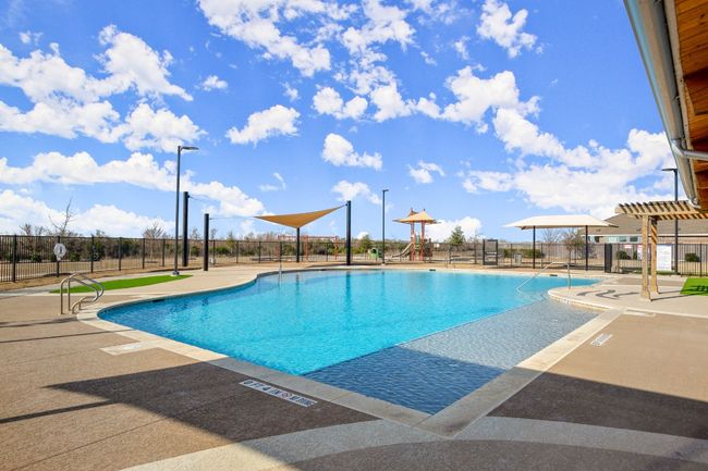 Community pool with fence and a patio | Image 28
