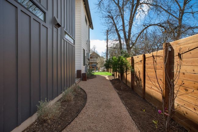 View of side of home featuring board and batten siding and fence | Image 34