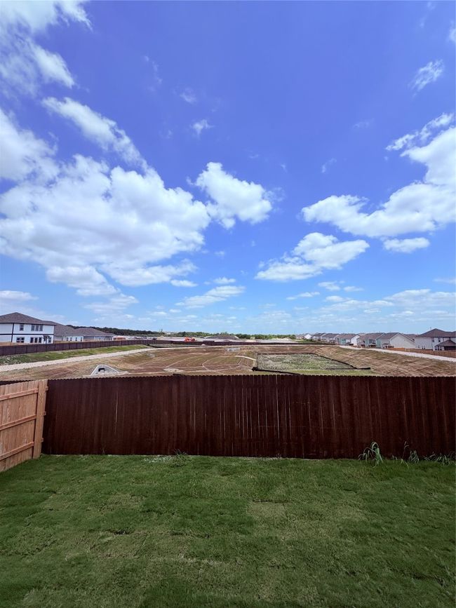 View of yard featuring fence and a residential view | Image 40