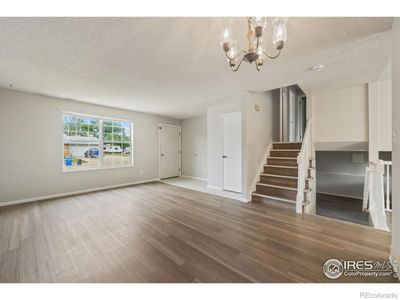 Living room window and split stairs going up and down. | Image 3