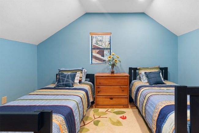 Carpeted bedroom with vaulted ceiling | Image 25