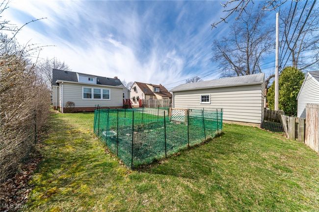 Back of house with a lawn and a vegetable garden | Image 40