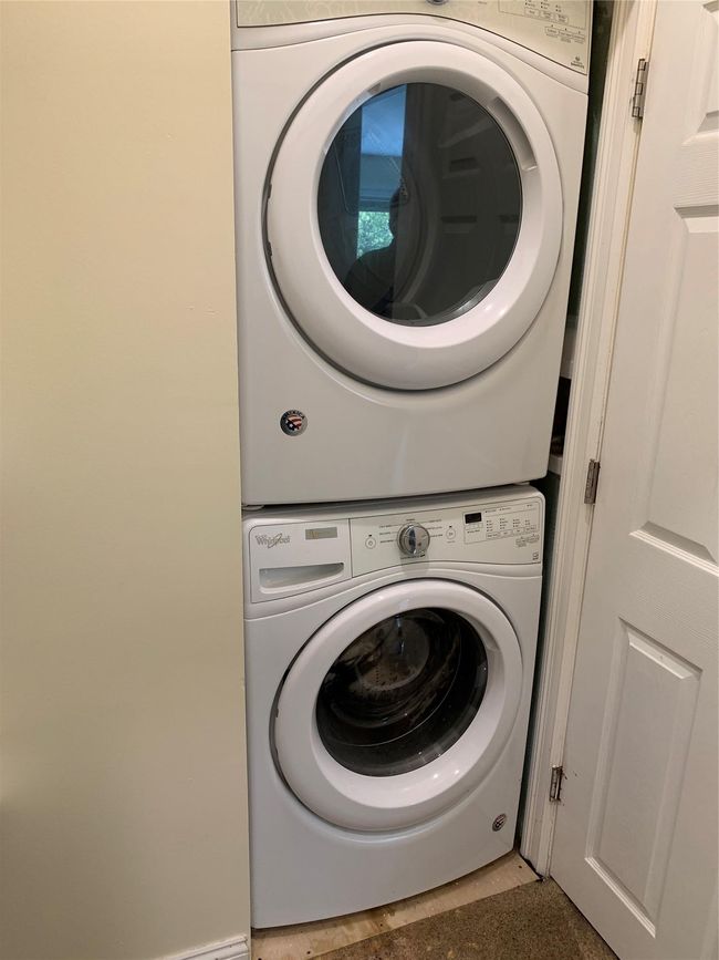 Clothes washing area featuring stacked washer and clothes dryer located on 2nd floor. | Image 18