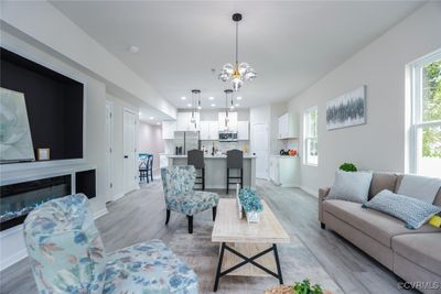 Living room featuring light wood-type flooring and a chandelier | Image 3