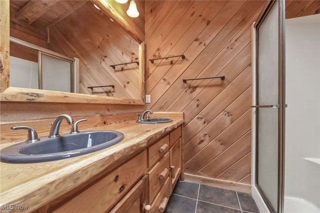 View of dual vanity, standalone shower and tile floor in primary bathroom | Image 26