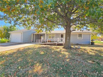 Single story home with a carport and a garage | Image 1