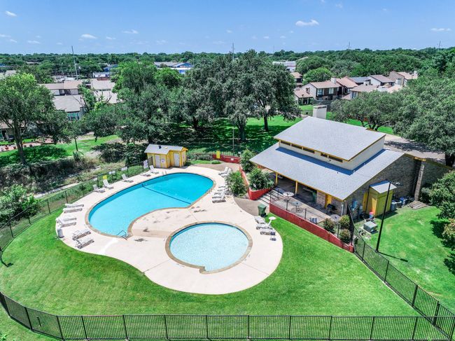 Another view of community pool and community center, just a short walk across the greenbelt behind the home. | Image 25