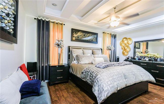 Bedroom featuring a tray ceiling, ceiling fan, and dark hardwood / wood-style floors | Image 20