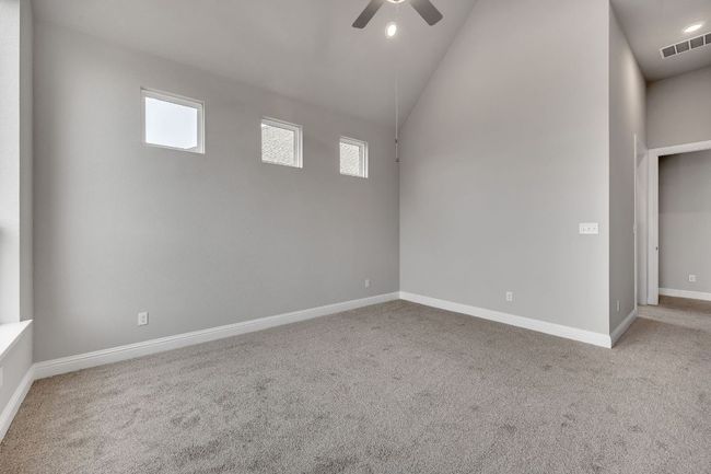 Spare room with baseboards, carpet floors, visible vents, and a ceiling fan | Image 16