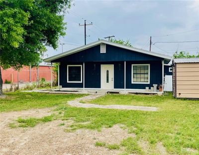 View of front facade featuring covered porch and a front lawn | Image 1