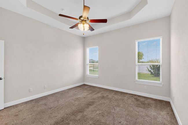 Unfurnished room featuring carpet and a ceiling fan | Image 26