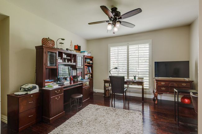 Office area featuring a ceiling fan and dark wood-style flooring | Image 6
