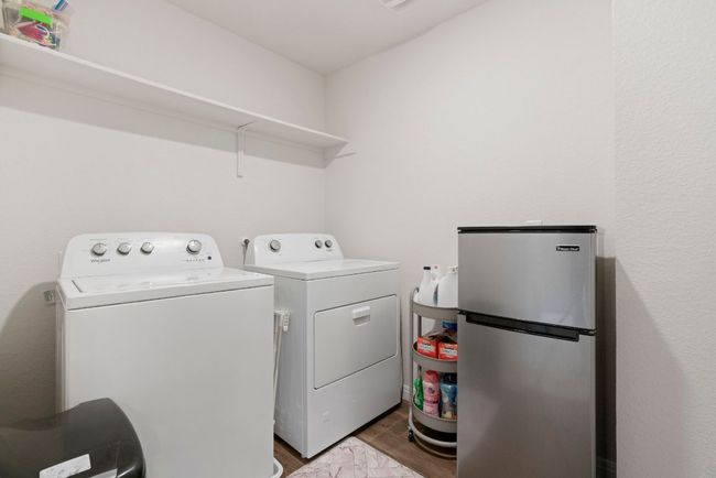Laundry room with washer and clothes dryer and wood finished floors | Image 25