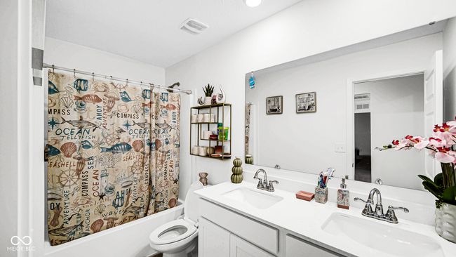 bathroom featuring double vanity, shower / tub combo, and toilet | Image 29