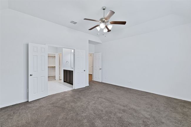 Unfurnished bedroom with carpet, high vaulted ceiling, and ceiling fan | Image 14