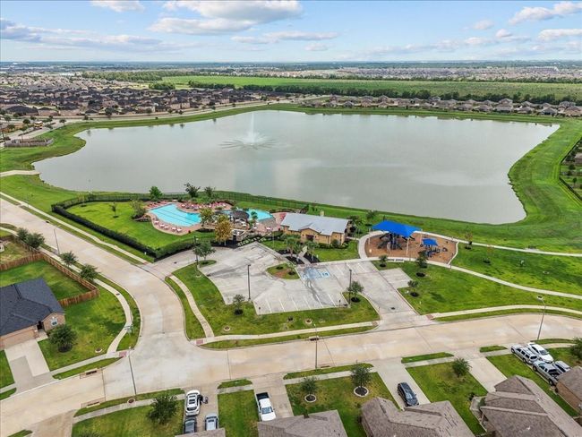 Beyond the front door: an extraordinary lifestyle! This aerial view captures the essence of community living, featuring a sparkling pool and a wealth of amenities. | Image 26