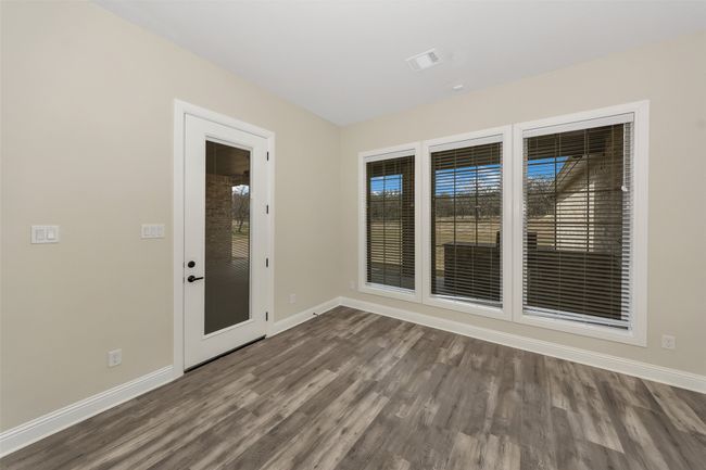 Empty room with visible vents, wood finished floors, baseboards, and a healthy amount of sunlight | Image 17