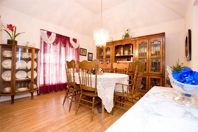 Formal Dining space featuring a chandelier, light wood-style flooring, and lofted ceiling | Image 5