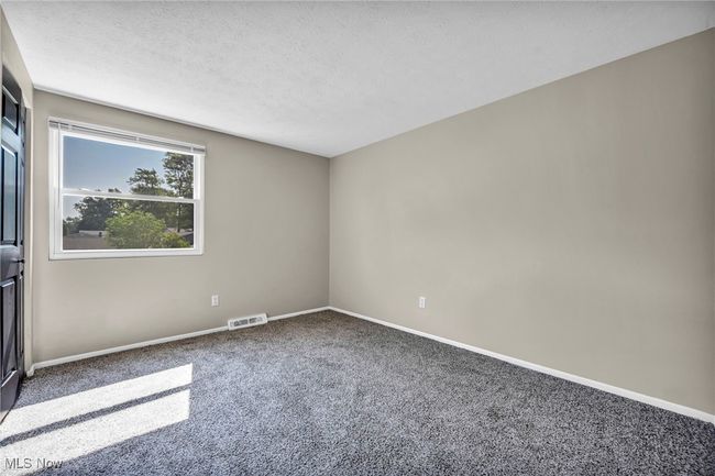 Empty room with carpet and a textured ceiling | Image 18