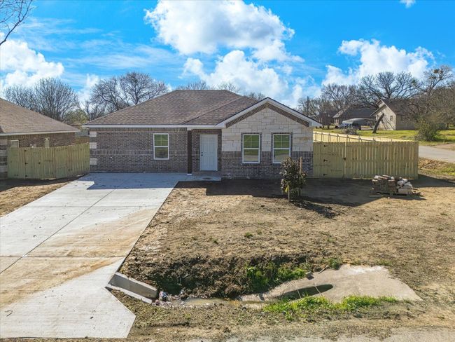 View of front of property featuring brick siding, roof with shingles, and fence | Image 4