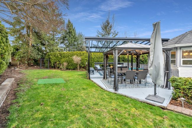 View of yard featuring a gazebo, a patio, and a fenced backyard | Image 35