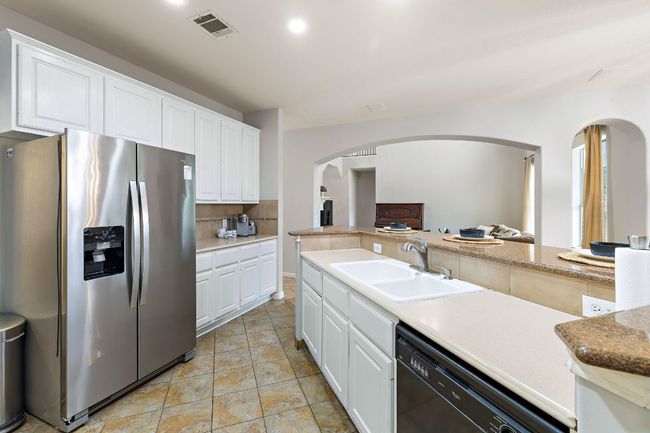 The kitchen has lots of countertop space and opens to the living room and breakfast nook. | Image 20