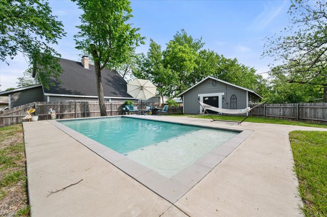 View of pool featuring an outbuilding, a fenced backyard, and a patio | Image 32