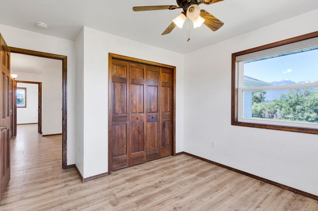 Unfurnished bedroom with light wood-style floors, baseboards, and multiple windows | Image 44