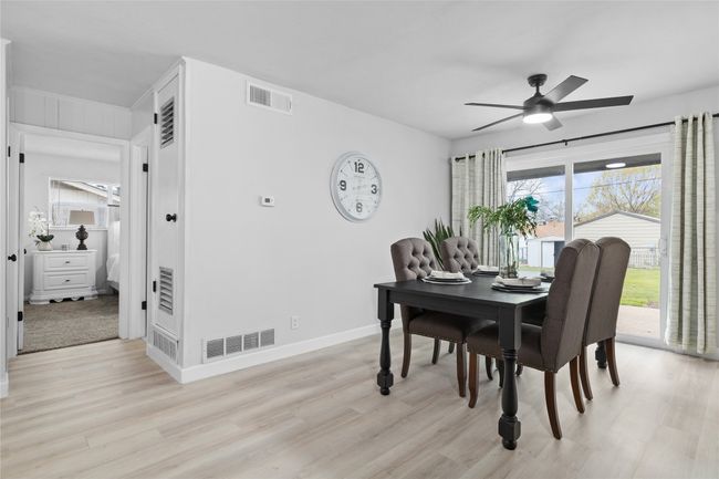 Dining space featuring baseboards, a ceiling fan, visible vents, and light wood-style floors | Image 9