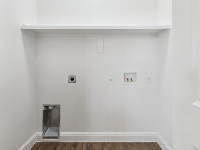 Clothes washing area featuring dark wood finished floors, laundry area, gas dryer hookup, electric dryer hookup, and washer hookup | Image 15