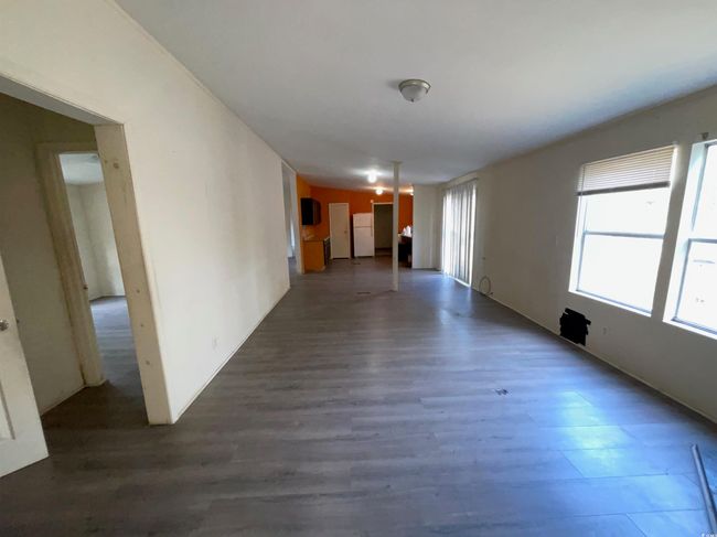 Unfurnished living room featuring wood finished floors | Image 7
